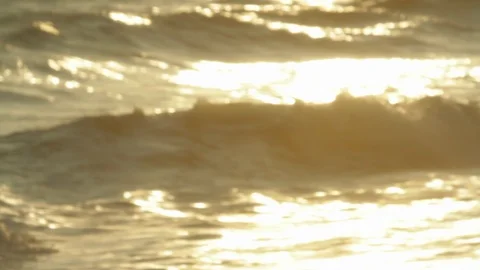Ocean beach sunset. Waves going out of focus. Bokeh sun on the water Stock Footage 102403305