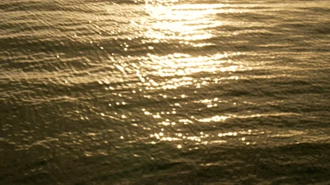 Ocean beach waves on beach at sunset time,sunlight reflect on water surface Stock Footage 134516797