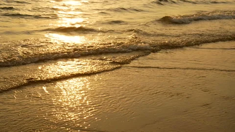 Ocean beach waves on beach at sunset time , sunlight reflect on water surface. Stock Footage 134609808
