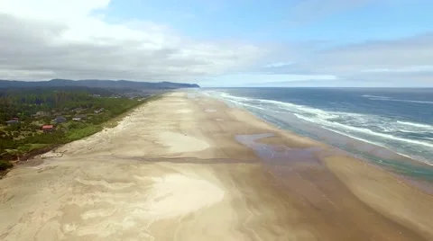 Ocean beach on a windy, cloudy  summer day at low tide Stock Footage 52135726