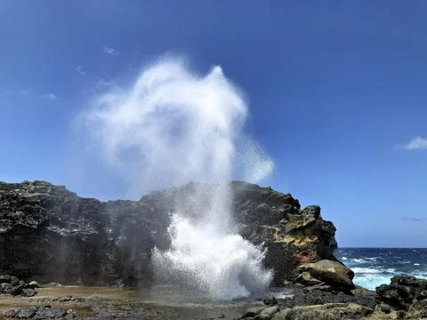 Ocean Blowhole Creating Powerful Stream of Sea Mist on Volcanic Coast Stock Photos