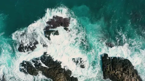 Ocean blue waves break on high cliff of a rocky mountain. Danger sea waves on a  動画素材 133180044