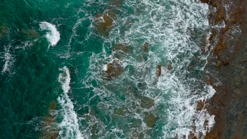 Ocean blue waves break on high cliff of rocky mountain. Turquoise sea crashing Stock Footage 306537342