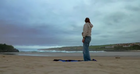 Ocean Breeze Exercise: A lone individual performs an exercise Stock Footage 333231991