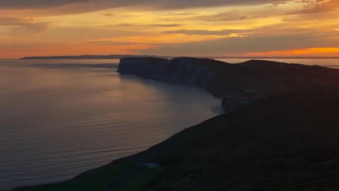 The ocean is calm and the sky is orange Stock Footage 298292013
