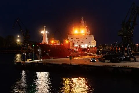 Ocean cargo ship loading at dock. Stock Photos
