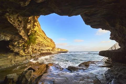 Ocean Cave View with Sandstone Cliffs and Blue Sky at California Beach Stock Photos