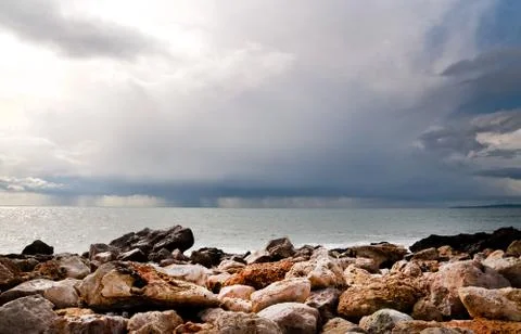 Ocean cloud and rocks Stock Photos