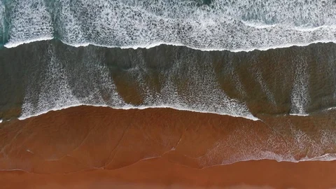 Ocean coast background. Foamy waves of turquoise ocean coming to a brown sand Stock Footage 100355931