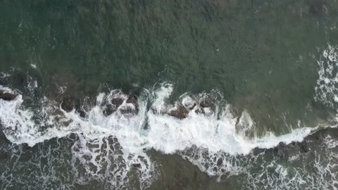Ocean coast with brown rocks around green sea Video stock 236642939