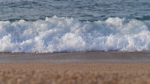 Ocean coast. Sandy beach, blue waves with sea foam. 4K Slow Mo Stock-Footage 114888574