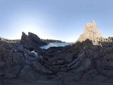 Ocean crashing over jagged basalt rocks 360 seated height Stock Footage 80360455