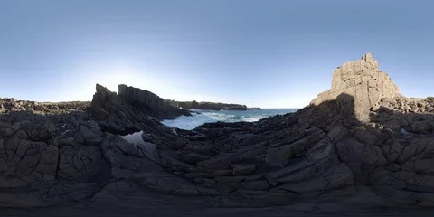 Ocean crashing over jagged basalt rock 360 Standing Height Stock Footage 80664041