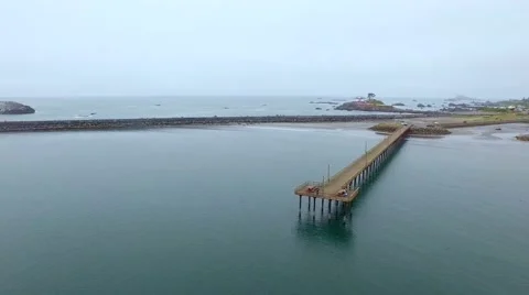 Ocean dock with a lighthouse in background Stock Footage 52132664