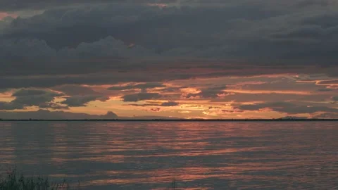 Ocean at dusk beneath a cloudy sky Stock Footage 137929481