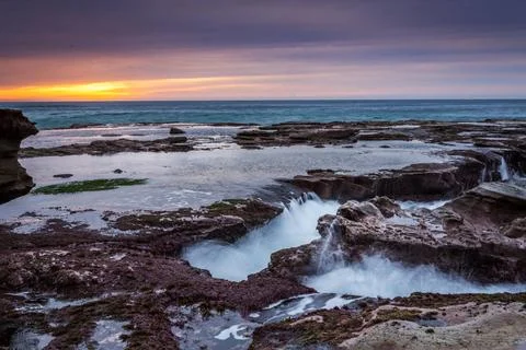  Ocean eroding out channels in the rocks The constant flow of water onto t... Foto stock