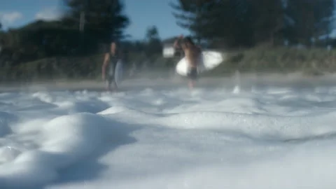 Ocean foam view with surfer on the beach Stock Footage 169312972