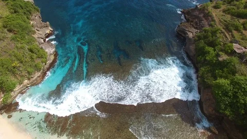Ocean foamy waves roll on deserted beach in lagoon Stock Footage 111777775