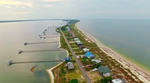 Ocean front lagoon flyover on a calm, cloudy day Stock Footage 54942774