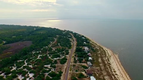 Ocean front lagoon flyover on a calm, cloudy day Stock-Footage 54942817