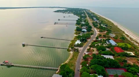 Ocean front lagoon flyover on a calm, cloudy day Stock Footage 54943446