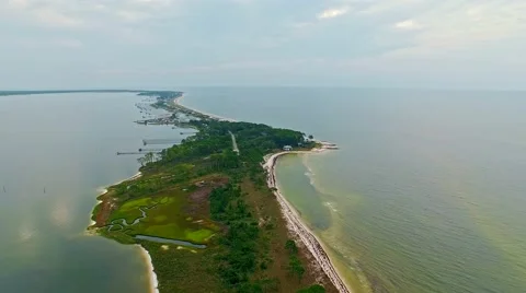 Ocean front lagoon flyover on a calm, cloudy day Stock Footage 54943502