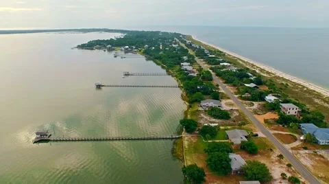 Ocean front lagoon flyover on a calm, cloudy day Stock Footage 54943544