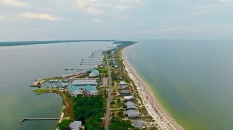 Ocean front lagoon flyover on a calm, cloudy day Stock Footage 54943789
