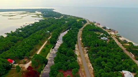 Ocean front lagoon flyover on a calm, cloudy day Video stock 54944244