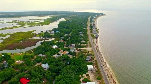 Ocean front lagoon flyover on a calm, cloudy day Stock Footage 54944890