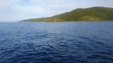 Ocean with green mountain background Stock Footage 293992287