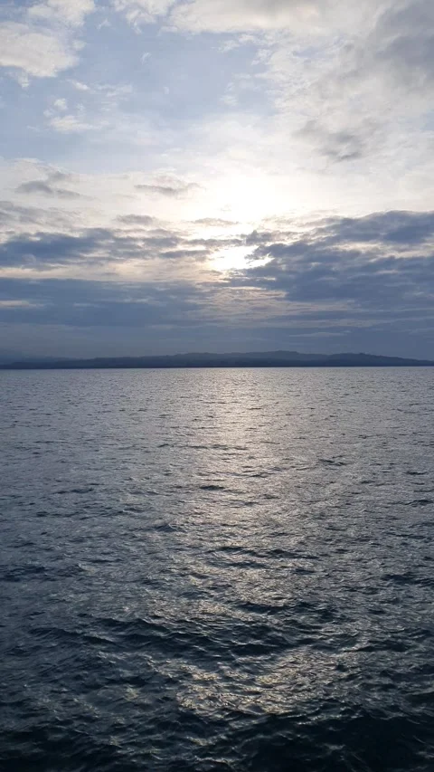 Ocean with green mountain background Stock Footage 293995946