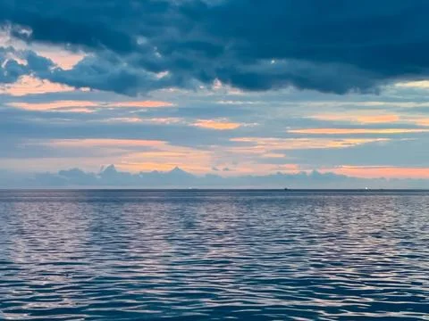 Ocean Horizon At Sunset With Clouds Stock Photos