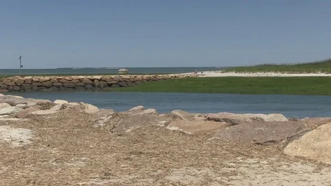 Ocean inlet with jetty, rocks in foreground Stock Footage 76682263