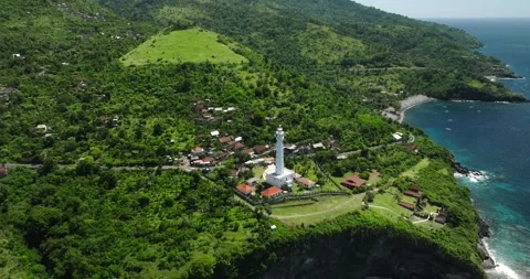 Ocean lighthouse perched on cliff with stunning aerial view 스톡 동영상 274523813