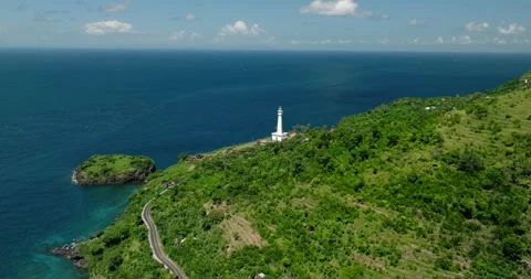 Ocean lighthouse perched on cliff with stunning aerial view Stock Footage 276090210