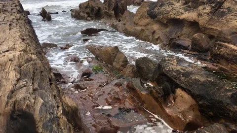 Ocean with Lineal/Geometric Rocks Stock Footage
