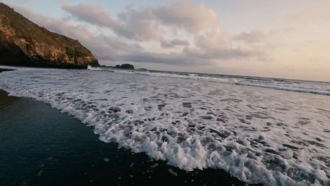 Ocean long calm  waves on black sand beach in Tenerife on the sunrise Stock Footage 116471300
