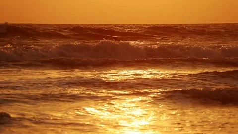 On the ocean orange sunset and waves sparkle in the sun. Romance and relaxation Stock Footage 107971231