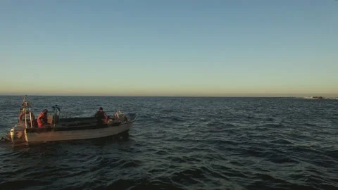 Ocean with panoramic sky background and fishermen on boat adjusting nests Stock Footage 160810734