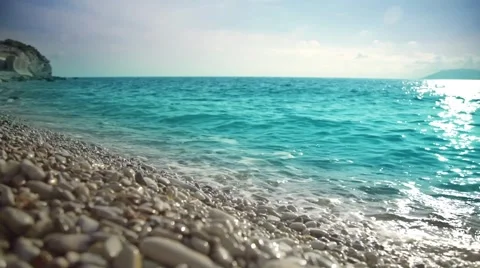Ocean, peeble shore and waves. Seascape at sunset or sunrise. Stock Footage 64004066