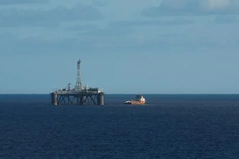 Ocean Platform With Red Boat On Open Ocean Stock Photos