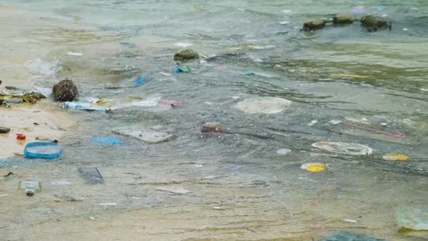 Ocean pollution with polluted beach with plastic waste and debris on the sea Stock Footage 287350071