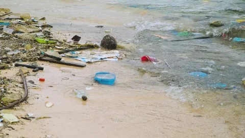 Ocean pollution with polluted beach with plastic waste and debris on the sea Stock Footage 295055197