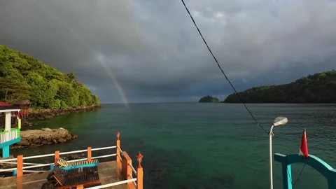 Ocean rainbow view under a cloudy morning sky Stock Footage 321260375