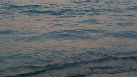 Ocean in the rays of the setting sun. Ocean shore in purple sunset. Twilight. Stock Footage 134122406