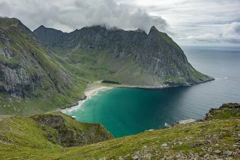 Ocean remote sandy beach surrounded by mountains view from Ryten peak, Lofote Stock Photos