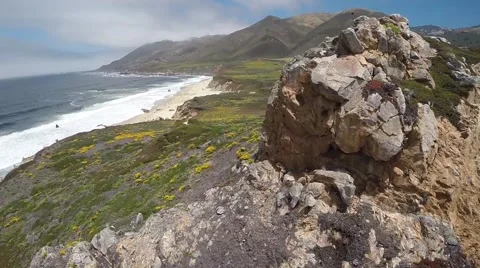 Ocean reveal aerial shot over a cliff Stock Footage