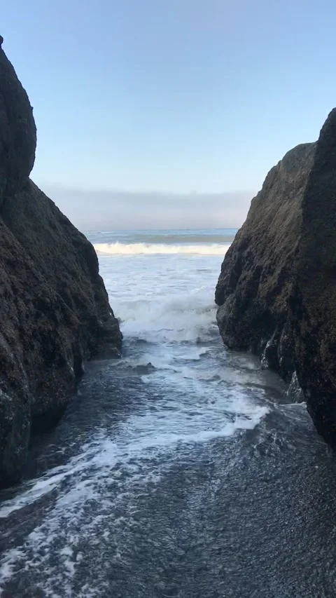 Ocean rising between sea stacks Stock Footage 242652952