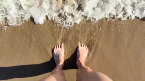 The ocean, river waves wash womans feet Stock Footage 340325998